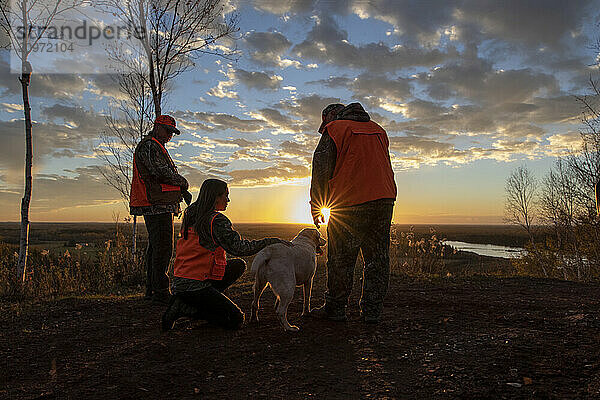 three people with dog going hunting  Minnesota  USA