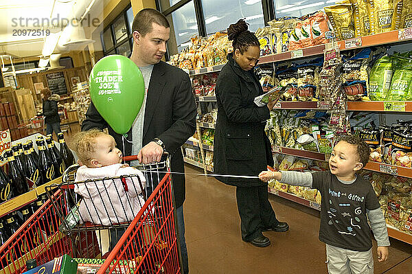 A young urban family shops for groceries.