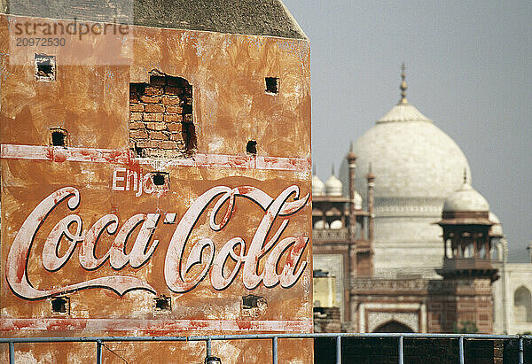 A Coca-Cola sign next to the Taj Mahal.