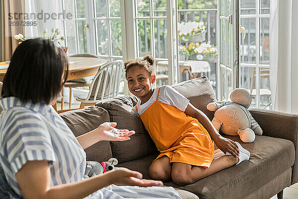 African American woman and daughter enjoy talking together