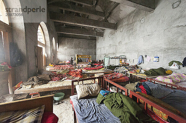 The cramped and rundown makeshift living quarters for labor workers at the San Huang Zhai Monastery on the Song Mountain  China.