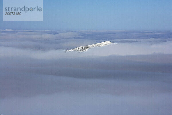 The very peak of Mt. Madison in the Presidential Range of New Hampshire surrounded by thick clouds.