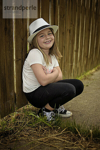 Happy young girl smiling wearing fedora hat