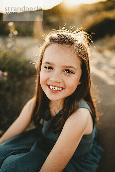 Beautiful Spanish little girl smiling happy beach sunset