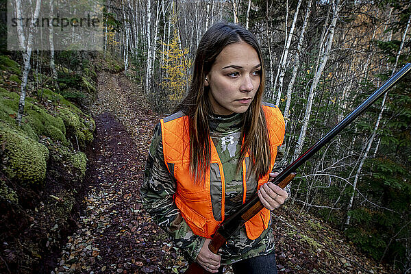 Portrait of young woman out hunting  Biwabik  Minnesota  USA