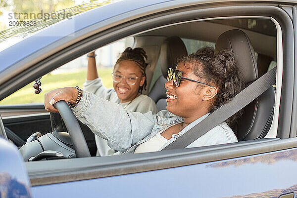 Young driver getting out of a car laughing