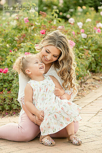 Mother and daughter laughing in garden