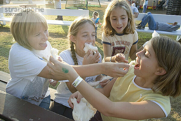 Girls enjoy Maple Sugar Cotton Candy at the Fryeburg Fair in Maine.