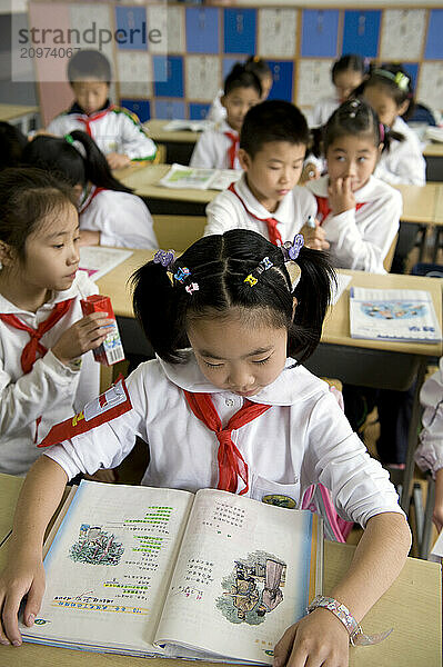 Young students practicing math on a chalkboard.