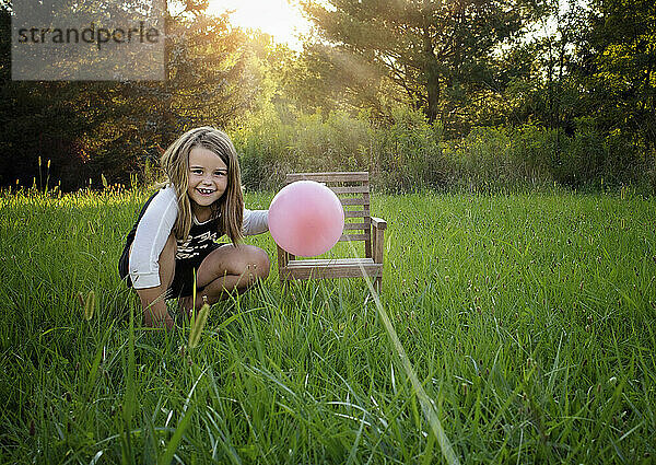 Happy young girl doing science experiment outdoors