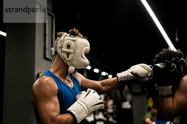 Boxers fighting in boxing training in the gym.