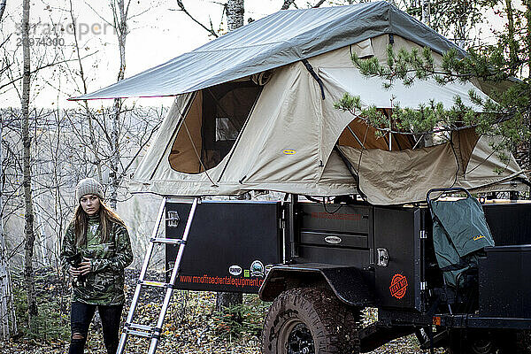 Young woman camping in forest  Biwabik  Minnesota  USA