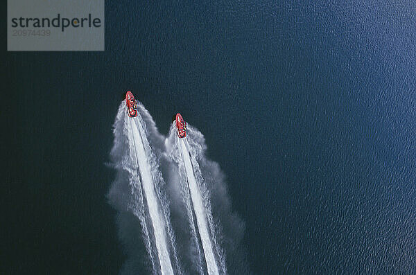 Aerial View of two jet skis racing across the lake.