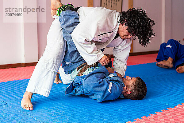 Judo fighters fighting in dojo