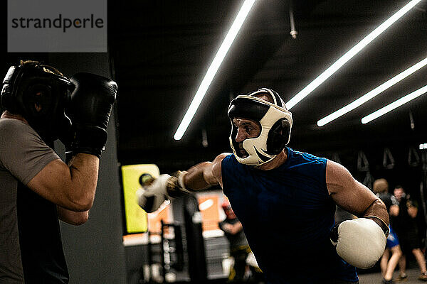 Boxers fighting in boxing training in the gym.