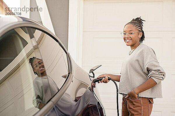 Young lady plugging in a charger at home