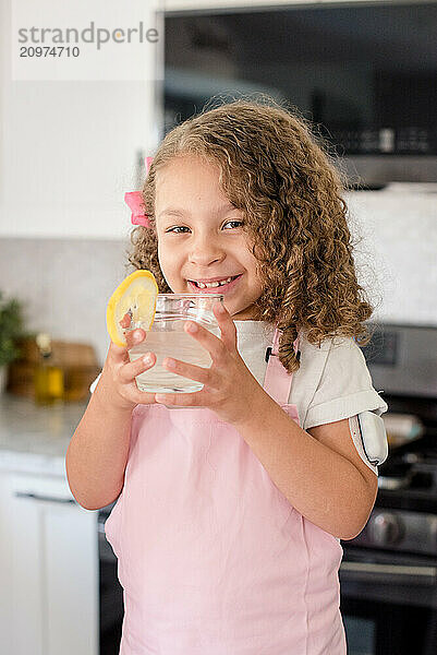 Little girl with diabetes holding a glass of lemonade