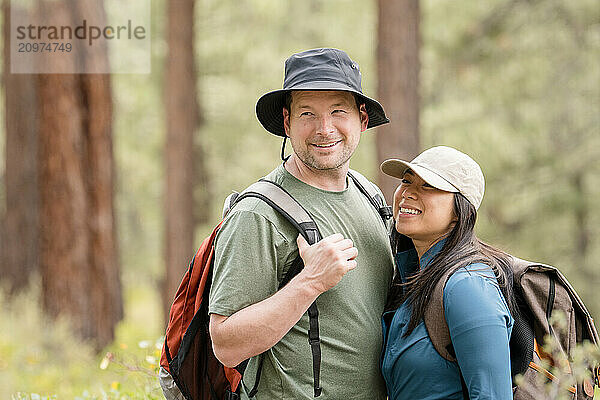 Close up of couple hikers laughing in the forest