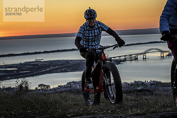 Man riding bicycle at dawn  Duluth  Minnesota  USA