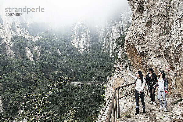 Tourists hiking to the San Huang Zhai Monastery on the Song Mountain  China.