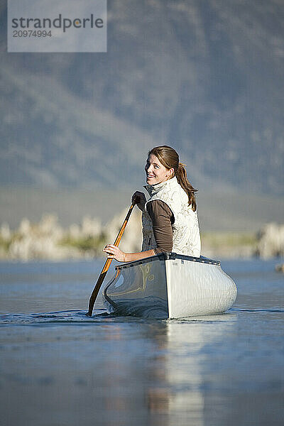 Young woman canoeing on Mono Lake. Lee Vining  CA