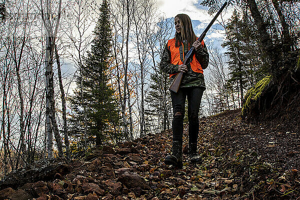 Young woman hunting grouse  Biwabik  Minnesota  USA