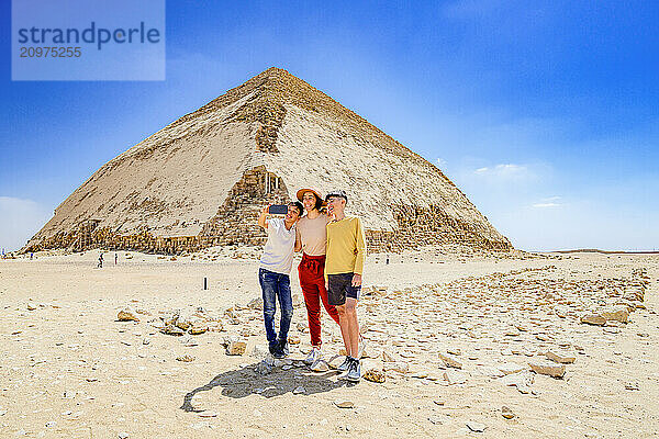 Happy family snapping a selfie at the Bent Pyramid  Dahshur  Egypt