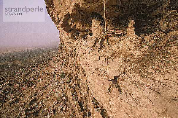 Man hanging from Bandiagara Cliffs  Mali