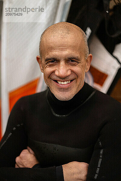 Portrait of confident kite surfer standing at beach.