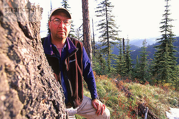 A man standing in a forest.