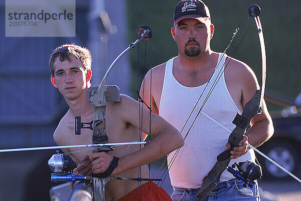 People preparing to fish with compound bows.