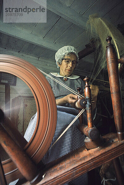 Rural heritage is demonstrated by a woman spinning wool.