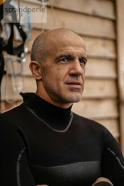 Portrait of confident kite surfer standing at beach.