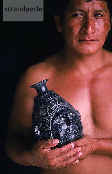 Man with a ceramic object.