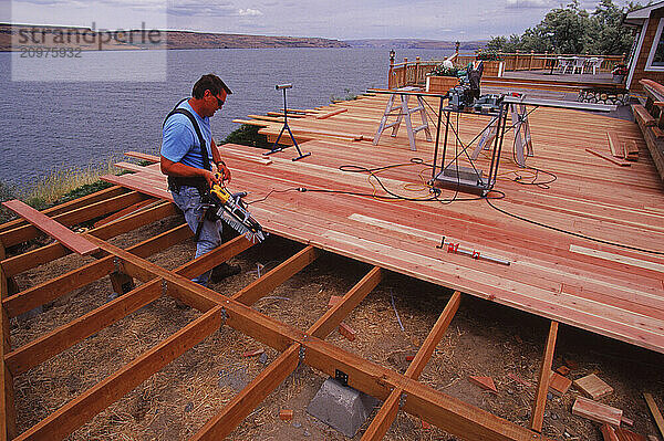 Man building a deck on his home.