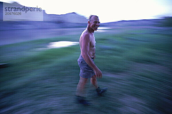 Man walking and smiling. (motion blur)