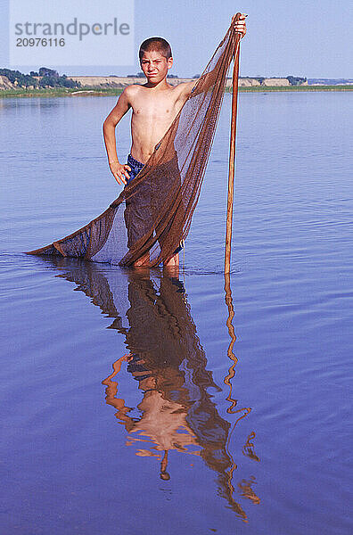 A boy with a river net.