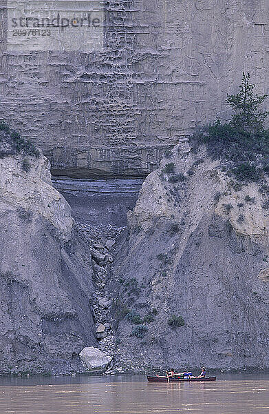 Rugged cliffs next to a river.