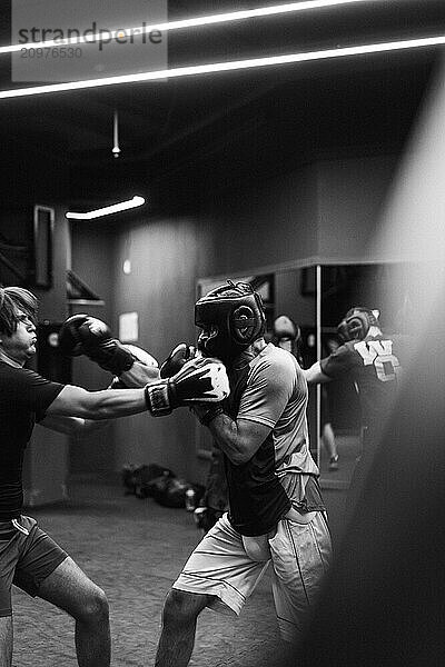 Boxers fighting in boxing training in the gym.