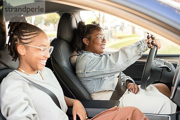 Friends laughing together while driving