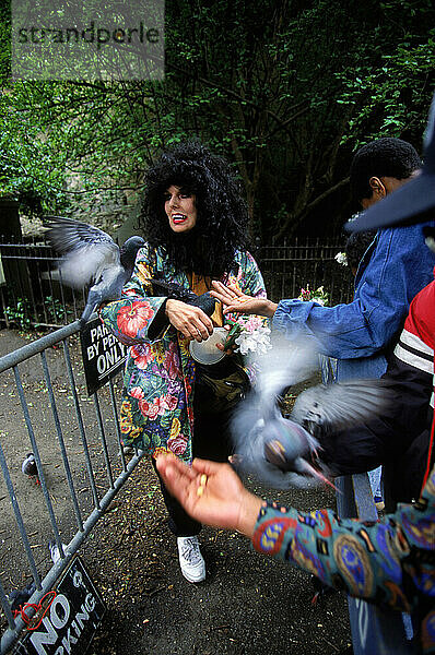 A woman who feeds pigeons regularly.