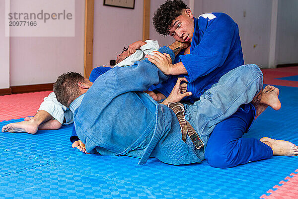 Judo fighters fighting in dojo