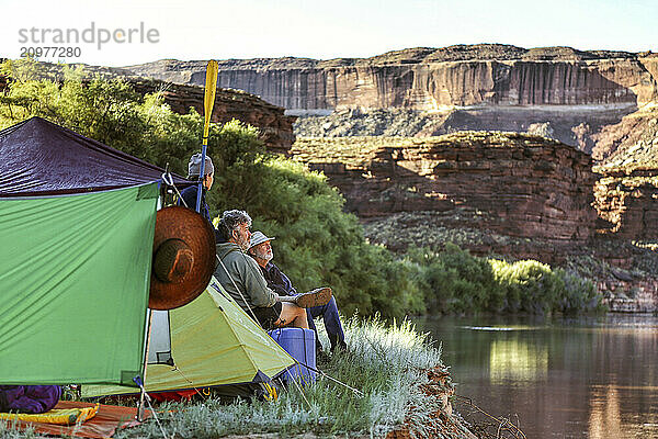 A multi-generational family of boaters looks out from their campsite at the Green River in Canyonlands National Park  Utah