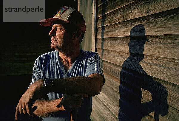 A man pauses in the late afternoon light of sunset.