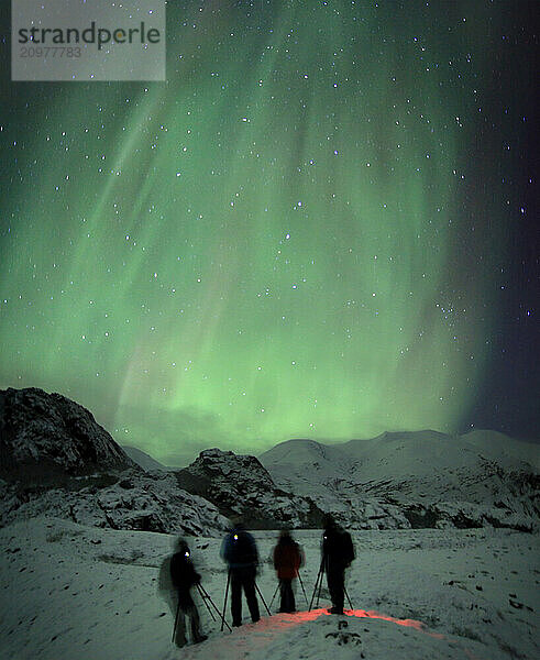 Photography group witnesses the aurora borealis over HoffellsjÃ¶kull  eastern Iceland.