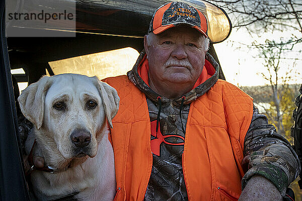 Portrait of senior man with dog  Biwabik  Minnesota  USA