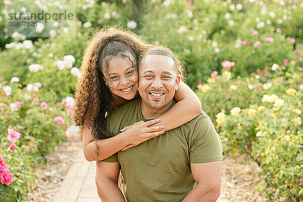 Daughter hugging father in garden