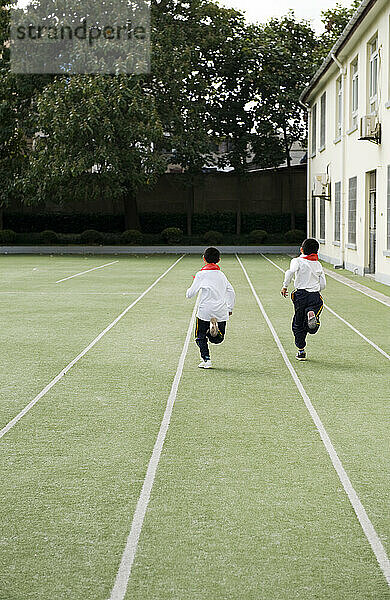 School children stretching during a physical fitness class.