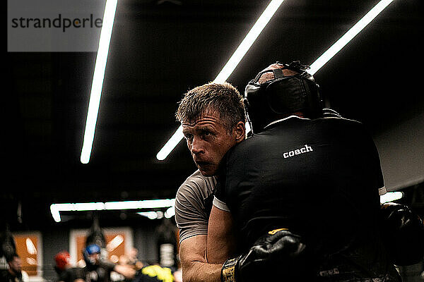 Boxers fighting in boxing training in the gym.