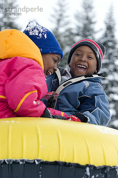 Young kids riding snowtube at Kirkwood ski resort near Lake Tahoe  California.